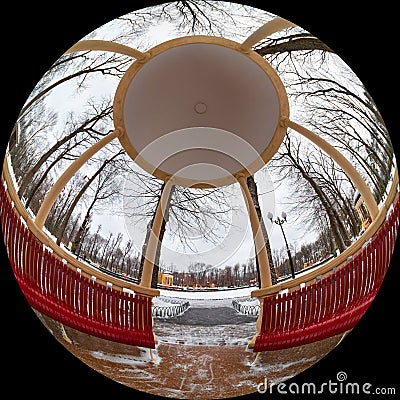 View from a gazebo with columns in a city park on a winter day. Shot through a circular fisheye lens Stock Photo