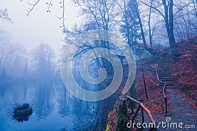 View of a gazebo in a foggy forest. Lake in the forest in the fog Stock Photo