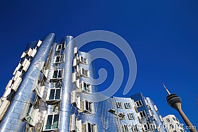 View on Gehry houses with silver shiny futuristic metallic aluminium facade with rheinturm Editorial Stock Photo