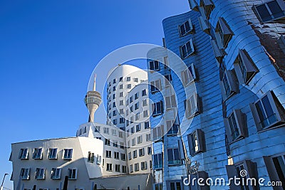 View on Gehry houses with silver shiny futuristic metallic aluminium facade with tv tower Editorial Stock Photo