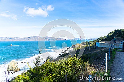 The view of golden gate bridge in Lands end at San Francisco- San Francisco. summer , cloud , rock , sea, plant. Editorial Stock Photo