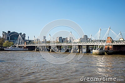 A view of Golden Jubilee and Hungerford bridges from South Bank of Thames River in London Editorial Stock Photo