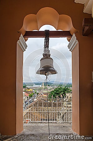 View of the Granada city through the arch of the bell tower of L Stock Photo