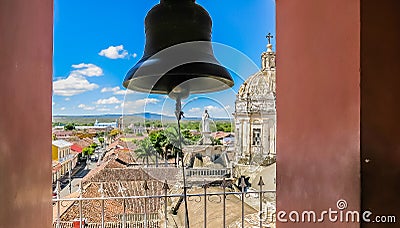 View of the Granada city through the arch of the bell tower of La Merced Church along the street Calle Real Xalteva with Iglesia Stock Photo
