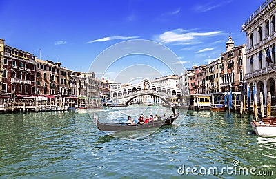 View of the Grand Canal, the Rialto Bridge and the gondola with tourists. Venice Editorial Stock Photo