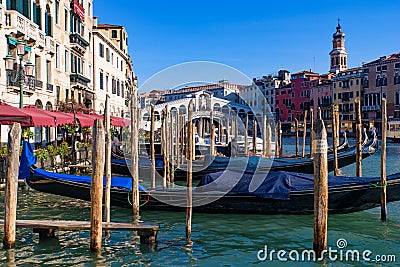 View of the Grand Canal, Rialto Bridge, and gondolas from outdoor restaurant seats, Venice Editorial Stock Photo