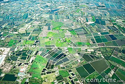 The view of green field and farm and city downtown in middle of Thailand. It shot from Jetplane Stock Photo