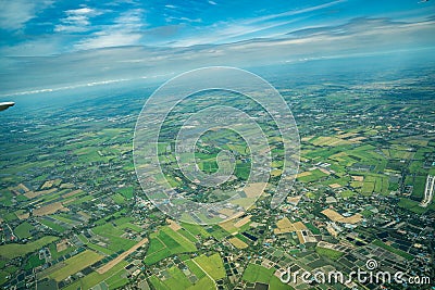 The view of green field and farm and city downtown in middle of Thailand. It shot from Jetplane Stock Photo