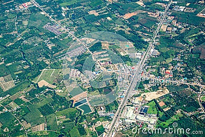 The view of green field and farm and city downtown in middle of Thailand. It shot from Jetplane Stock Photo