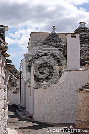 View of group of traditional trulli houses in the Aia Piccola residential area of Alberobello in the Itria Valley, Puglia Italy Stock Photo