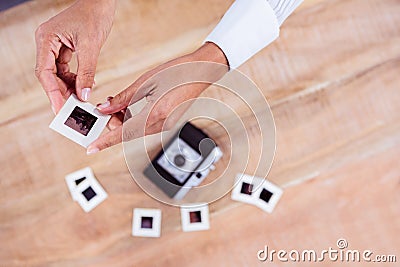 View of hands holding photo slides Stock Photo