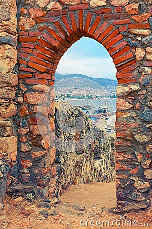 View of harbor through stone arch of Alanya Castle Editorial Stock Photo