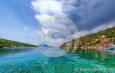 View on the harbour and island with mountains in Vathi village. Meganisi island Ionian sea Stock Photo