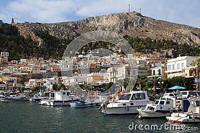 A view of the harbour and some old traditional fishing boat in front in Calymnos Island Stock Photo