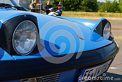 View of the headlights, hood and emblem of a blue Porsche 914. Editorial Stock Photo