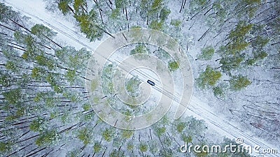 Aerial view on car driving through winter forest road. Scenic wi Stock Photo