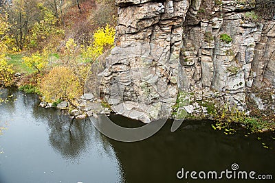 View of the high cliffs of the canyon. River and rocks. Autumn leaves fall in the river Stock Photo