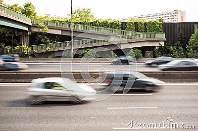 Speeding cars driving on the A4 highway in the suburbs of Paris with motion blur. Stock Photo