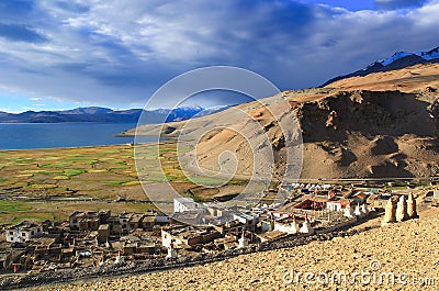 View from the hill to Himalayas, the fields, the lake Tso Moriri and the village Korzok, Ladakh, India. Stock Photo