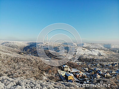 View from the hill to winter landscape with farmstead and forest, scenic winter view to valley, tranquil winter countryside, Stock Photo