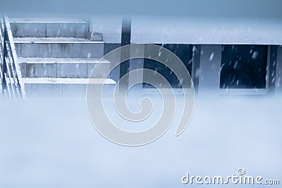 View through hole in the wall on winter scenery house stairs outdoors Stock Photo