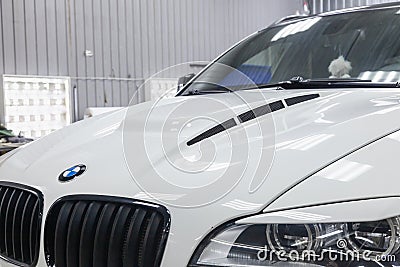 View of the hood and grille of luxury very expensive new white BMW X6 M Lumma CLR tuning car stands in the washing box waiting for Editorial Stock Photo