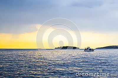 View of the horizon over the Adriatic Sea, with a boat sailing, during the sunset of a cloudy day while raining Editorial Stock Photo