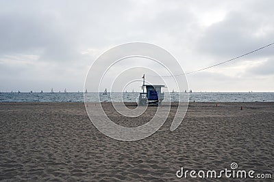 A view of horizon, seascape, ocean, sailing yachts and lifeguard in the beach in Venice, California in cloudy sky Editorial Stock Photo