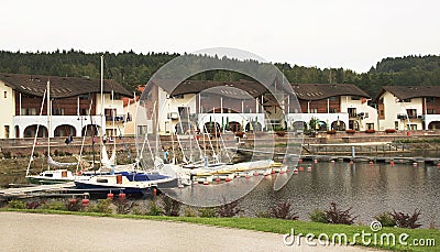 View on hotels of Lipno near lake with yachts. Editorial Stock Photo