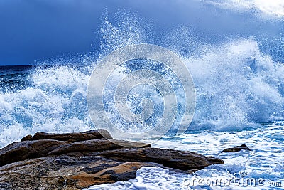 View of a huge storm at sea, with five meters high white splashing waves an threatening dark sky on the Mediterranean Sea in the s Stock Photo