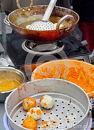 View of Indian street vendor making snacks Stock Photo