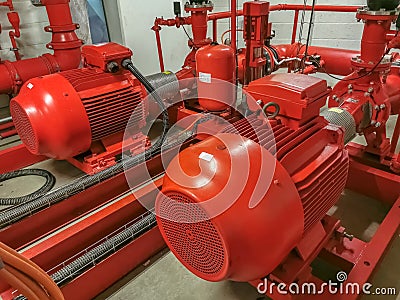 View at industrial electrically powered water pumps and pipes, this pumping group serves for water injection for building fires, Stock Photo