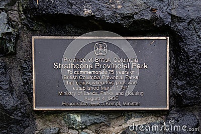 View of Information Board Plaque Strathcona Provincial Park on a stone wall Editorial Stock Photo