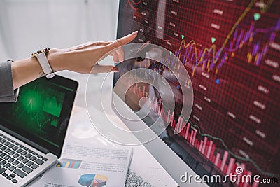 View of information security analyst pointing with finger on charts on computer monitor Stock Photo