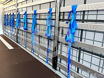 View inside the semi-trailer. Tie straps for securing loads hang on the side aluminum boards Stock Photo