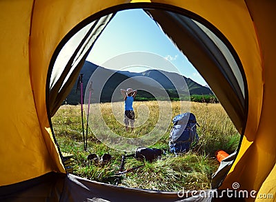 View from inside a tent on the girl and mountains Editorial Stock Photo