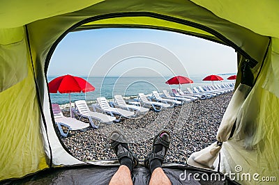 View from inside a tent on the sun loungers on a beach Stock Photo