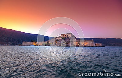 View of the island of Spinalonga with calm sea. Here were isolated lepers, humans with the Hansen`s desease, gulf of Elounda. Stock Photo