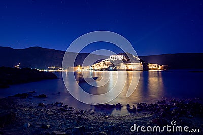 View of the island of Spinalonga with calm sea. Here were isolated lepers, humans with the Hansen`s desease, gulf of Elounda. Stock Photo