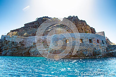 View of the island of Spinalonga with calm sea. Here were isolated lepers, humans with the Hansen`s desease, gulf of Elounda. Stock Photo