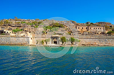 View of the island of Spinalonga with calm sea. Here were lepers, humans with the Hansen`s desease, gulf of Elounda. Stock Photo