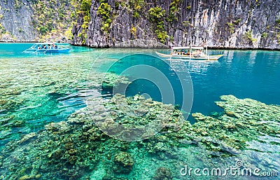 View of Kayangan Lake lagoon with tourists boat and coral reef Editorial Stock Photo