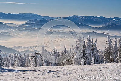 View from Kubinska Hola ski slope with ski lift during winter Stock Photo