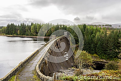 A view of Laggan Dam with 6 pipes to release water from the loch to river Spean, Scotland Editorial Stock Photo