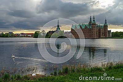 View of lake around renaissance Frederiksborg Castle with two sw Stock Photo