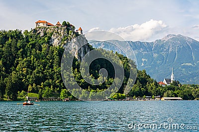 View of Lake Bled with Bled castle perched atop a steep cliff more than 100m above the lake Editorial Stock Photo