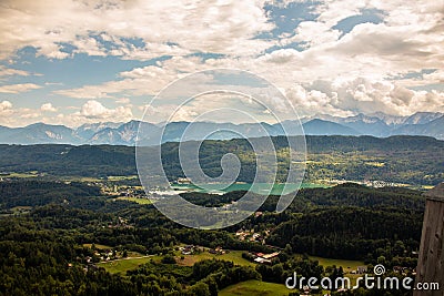 View from Lake WÃ¶rther See in the Austrian Alps overlooking a beginning storm with dark clouds and rain Stock Photo