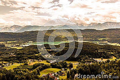 View from Lake WÃ¶rther See in the Austrian Alps overlooking a beginning storm with dark clouds and rain Stock Photo