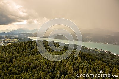 View from Lake WÃ¶rther See in the Austrian Alps overlooking a beginning storm with dark clouds and rain Stock Photo