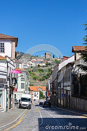 View at the Lamego city downtown street and exterior facade tower at Castle of Lamego, an iconic monument building on the top at Editorial Stock Photo